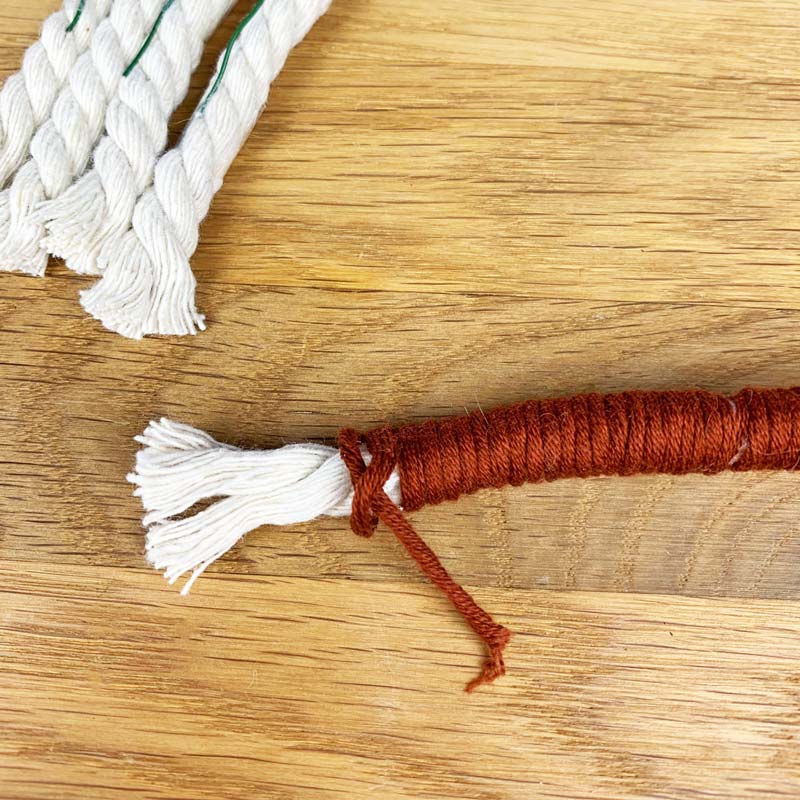 Make a small knot at the end and hide the rest of the thread